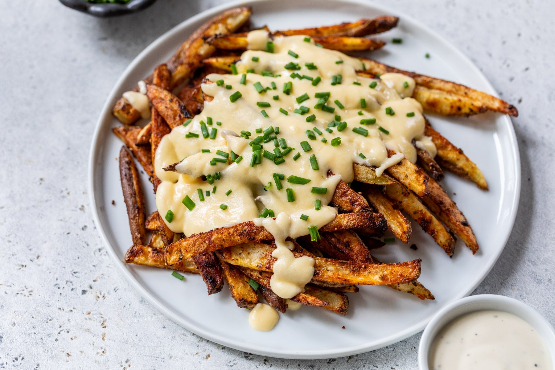 Voodoo Fries
This copycat version of Wingstop voodoo fries pairs Cajun-spiced oven-baked fries with homemade cheese sauce and ranch. Perfect for game day!