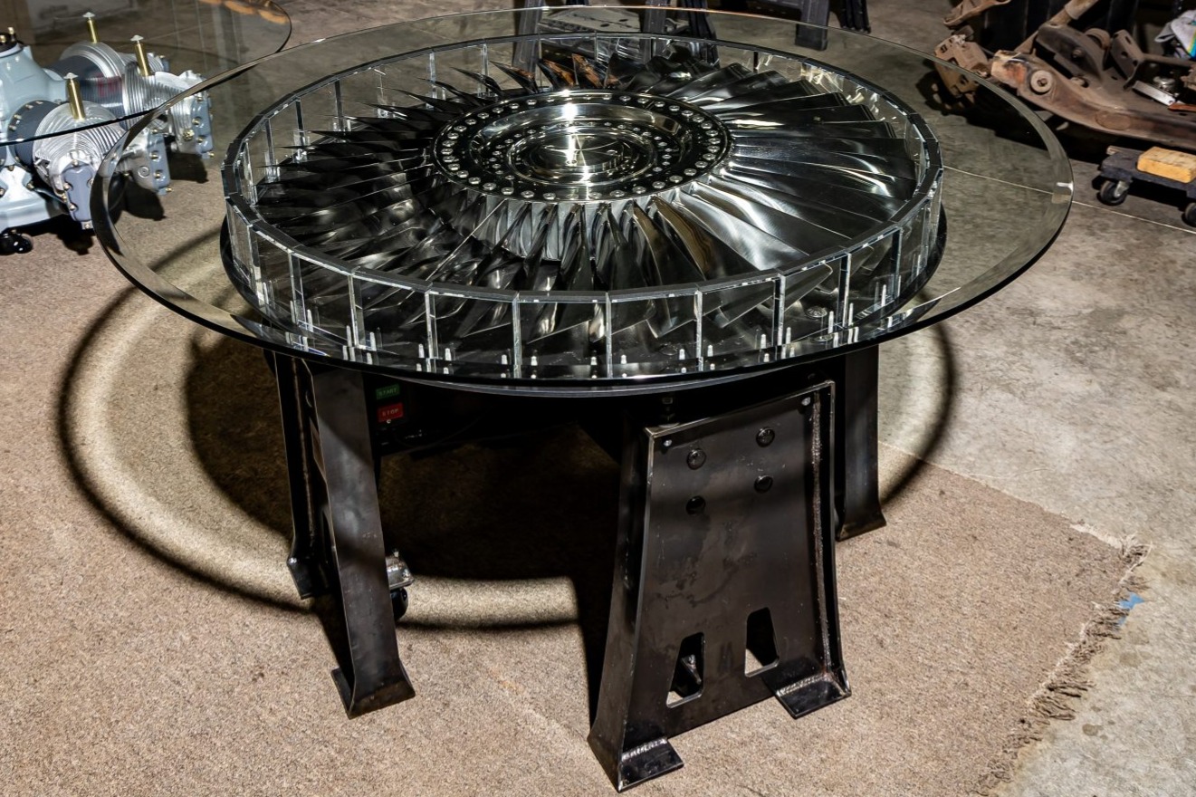 This table was built by the seller utilizing a turbine assembly from a JT8D engine manufactured by Pratt & Whitney Aircraft Company for a Boeing 737-200 commercial airliner. The hub and titanium blades were polished to a mirror finish, and a metal base was fa…
