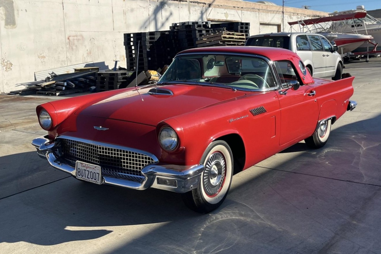 This Flame Red 1957 Ford Thunderbird was originally specified with a matching hardtop,&nbsp;Colonial White vinyl upholstery, and a 312ci V8 paired with a three-speed Fordomatic automatic transmission. It is further equipped with a Black soft top, wheel covers, fen…