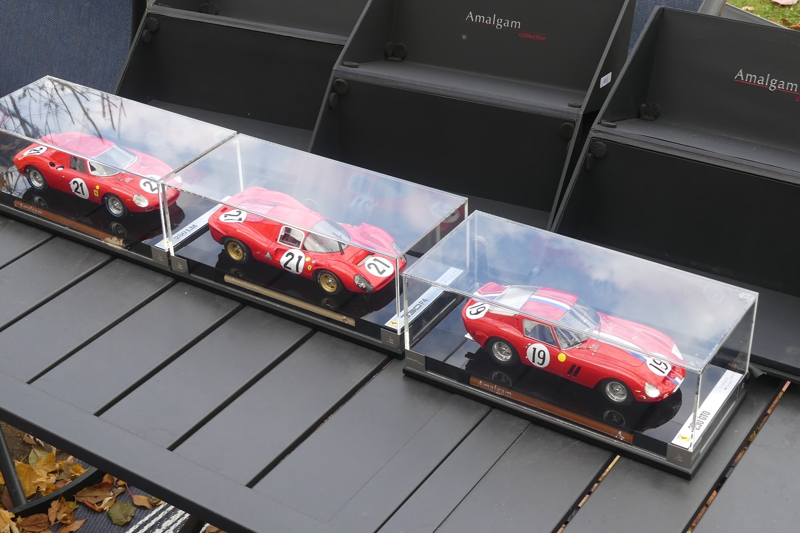 These three 1:18-scale Ferrari models were produced by Amalgam Collection in England and depict a 250 GTO, 250 LM, and 330 P4. Each model measures around 9" long, is constructed of resin, and is finished in red over a detailed interior. Details are rendered t…