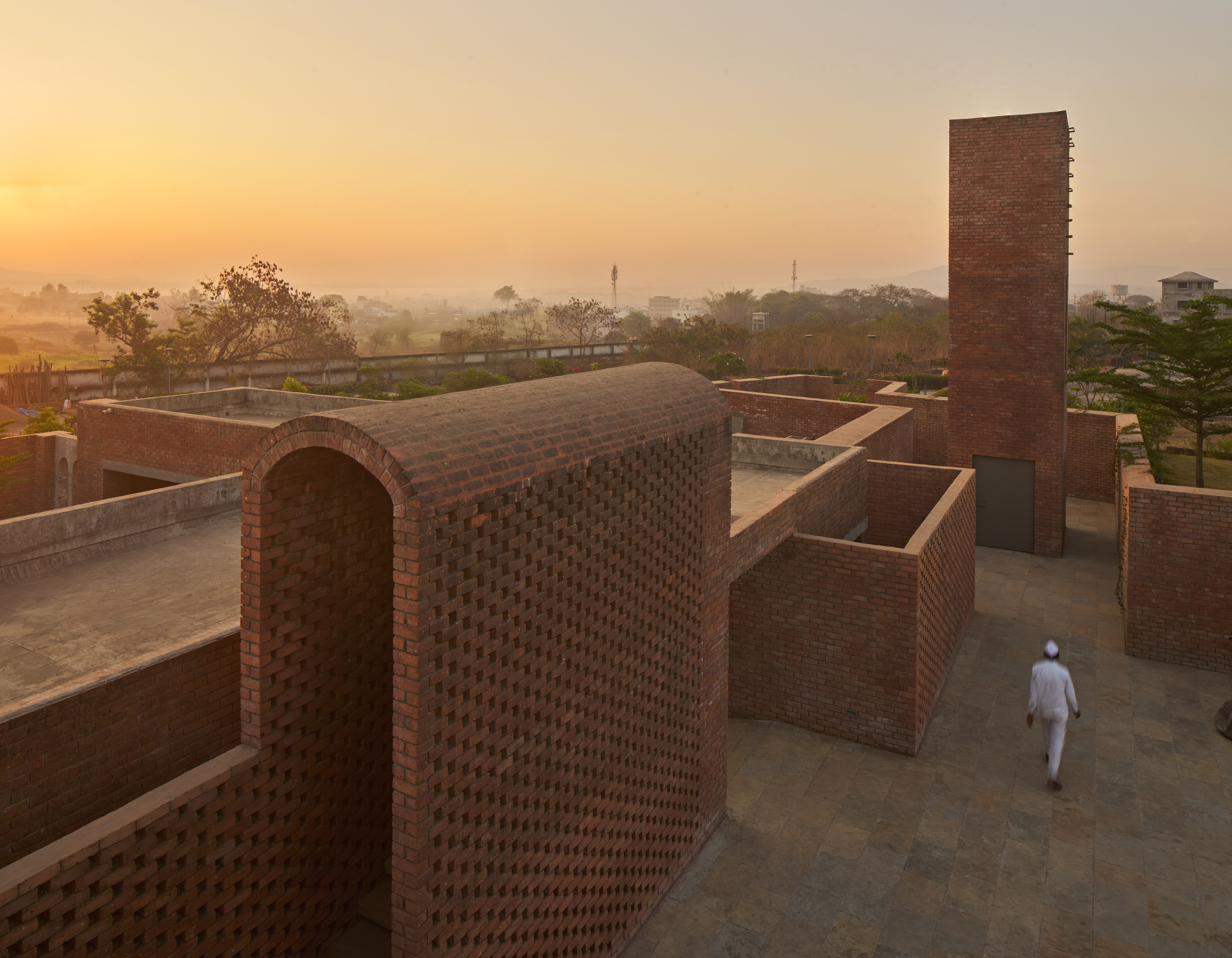 A brick clubhouse in Pune by Studio VDGA reflects the fluidity and openness of the Indian way of life with a series of welcoming plazas, courtyards and lanes