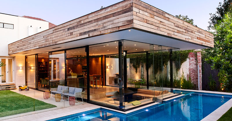 Techne Architects teamed up with OFTB, a landscape and swimming pool construction company, to create something special in Brighton, Australia, a lap pool and spa that doesn’t just sit in the backyard, but flows right up to the home’s interior sunken lounge.