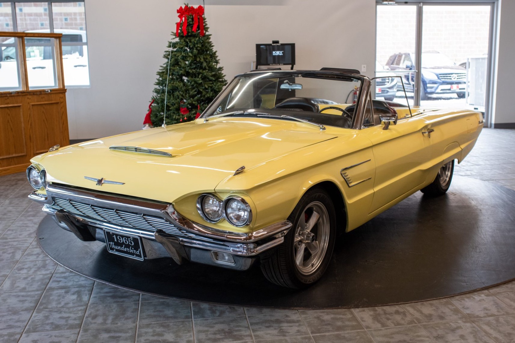 This 1965 Ford Thunderbird convertible is finished in yellow over black vinyl and is powered by a 390ci V8 paired with a Cruise-O-Matic three-speed automatic transmission. It rides on 17" Ridler wheels and is further equipped with a power-operated soft top, a…