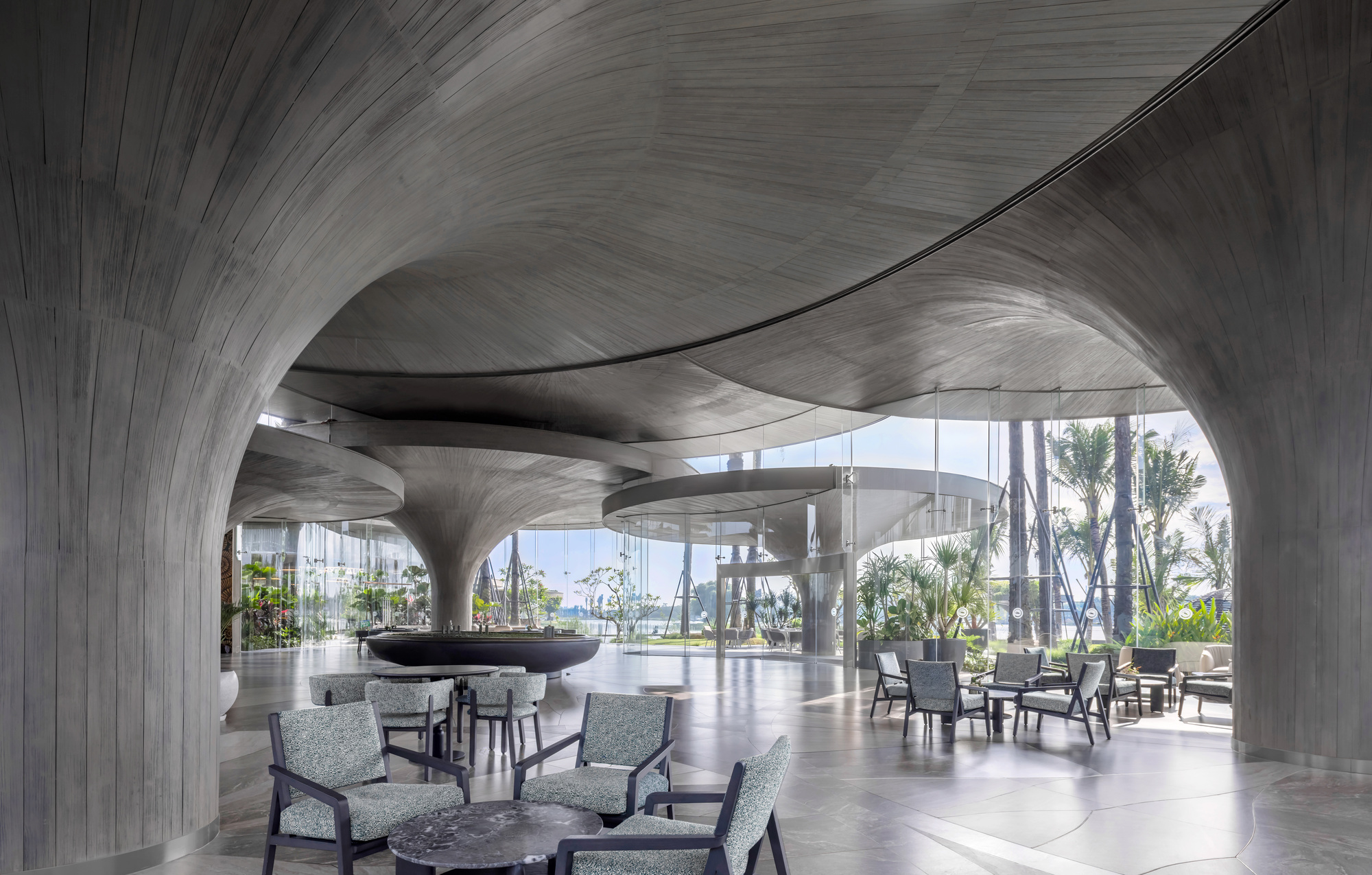 Lotus Clubhouse was conceived as a living organism that breathes in harmony with the terrain and surrounding natural environment. Rather than standing as an isolated architectural object, the building appears to emerge from the ground itself, shaped by natura…