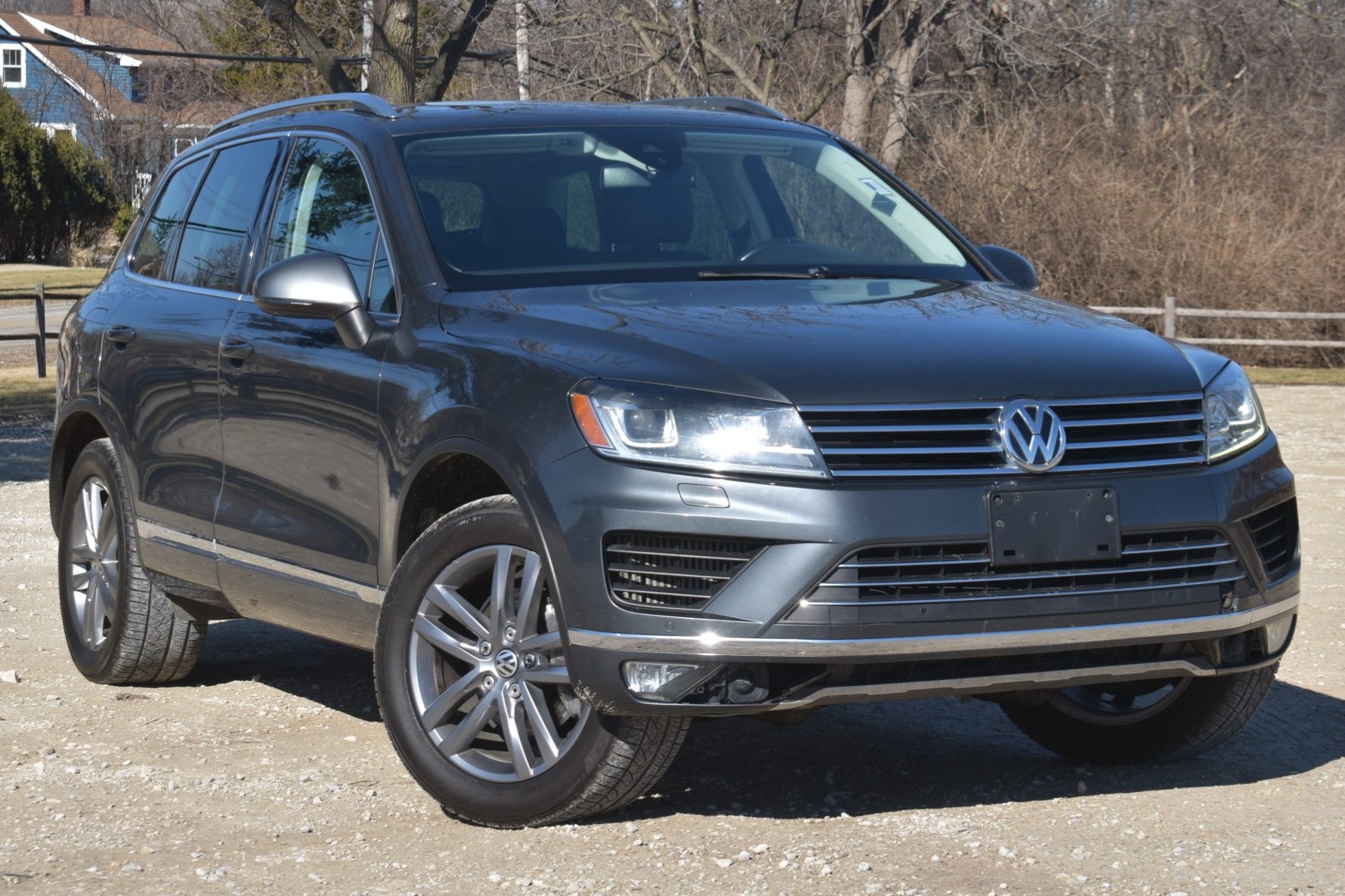 This 2016 Volkswagen Touareg Lux TDI is finished in gray over black Anthracite V-Tex leatherette, and it was factory optioned with the Driver Assistance Package, which added adaptive cruise control, Lane Assist, Lane Departure warning, and a heated steering w…