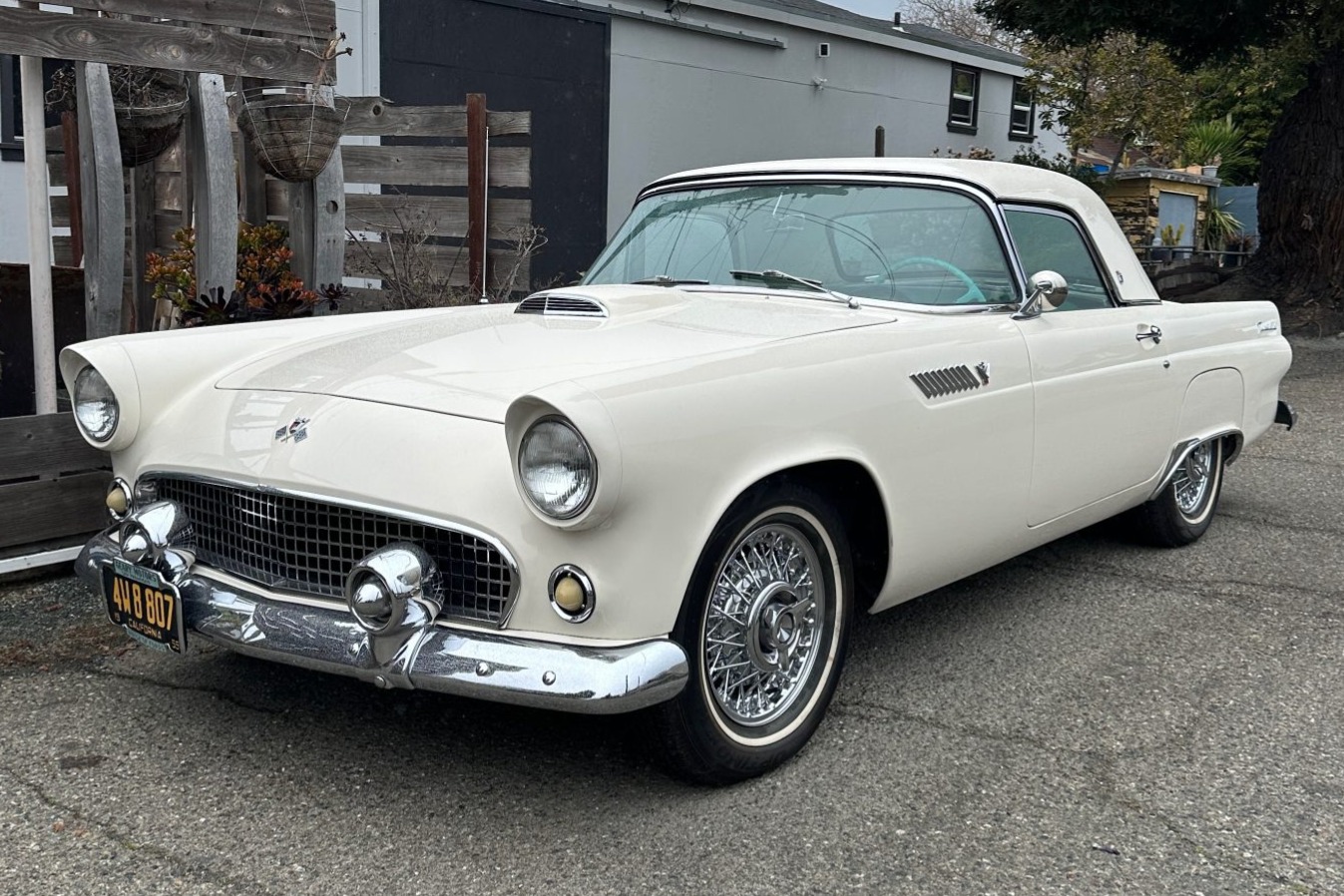 This 1955 Ford Thunderbird is finished in Snowshoe White over turquoise and white pleated vinyl and is powered by a 292ci V8 paired with a three-speed Fordomatic automatic transmission. Equipment includes a body-color removable hardtop, a black soft top, powe…