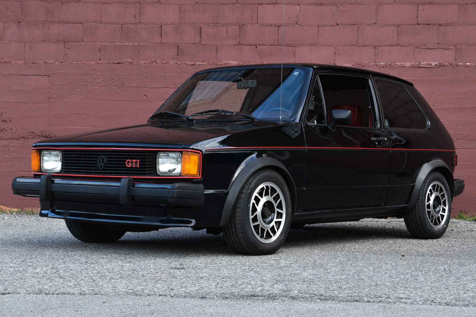 This 1983 Volkswagen Rabbit GTI is finished in black over Cordovan striped cloth and is powered by a fuel-injected 1.8L inline-four paired with a five-speed manual transaxle. Features include 14" Snowflake wheels, front disc brakes, a sunroof, and air conditi…