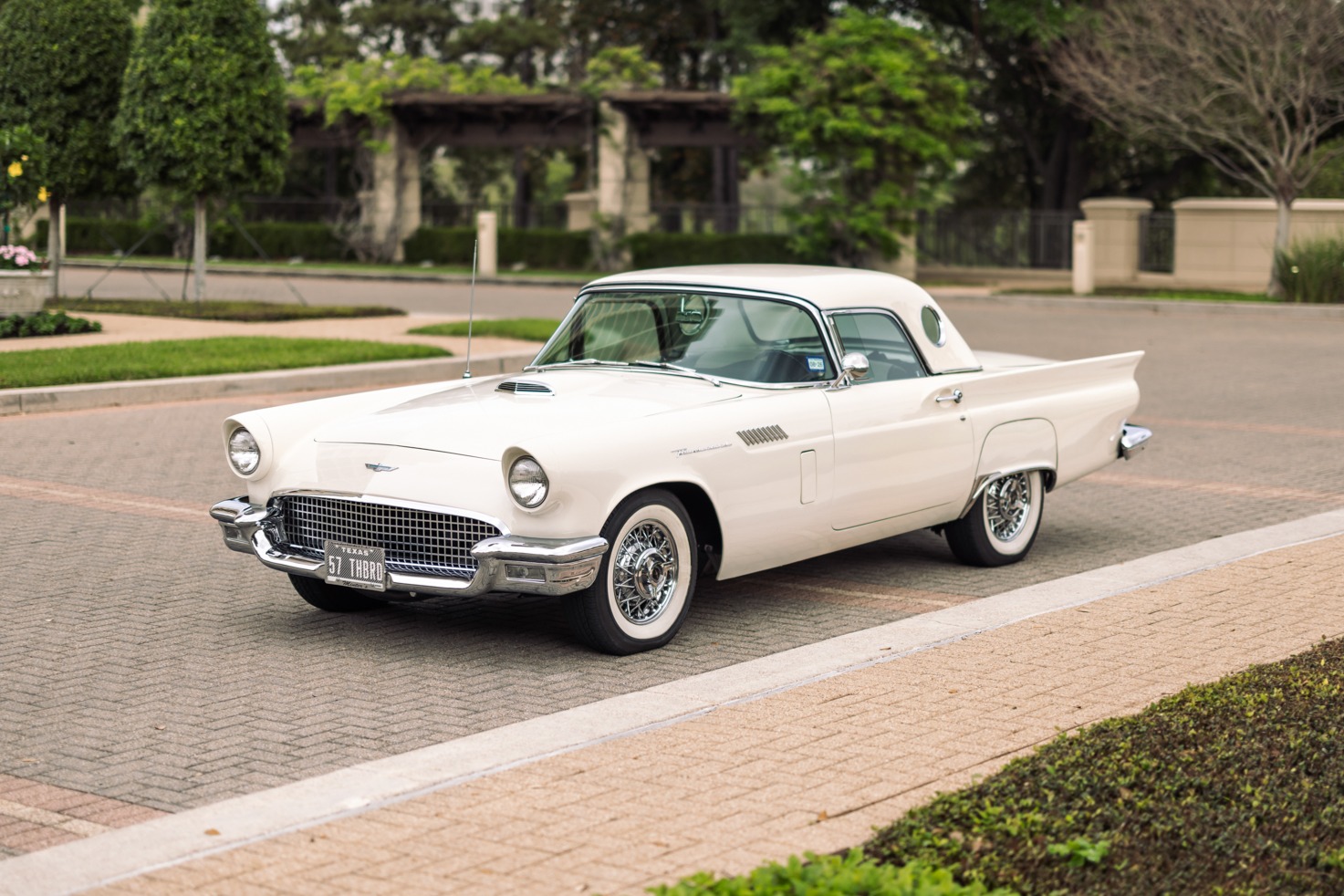 This 1957 Ford Thunderbird is powered by a 312ci V8 paired with a three-speed Fordomatic automatic transmission, and it was specified in Colonial White over a black and white interior. The car has a body-color removable hardtop with porthole windows and is al…