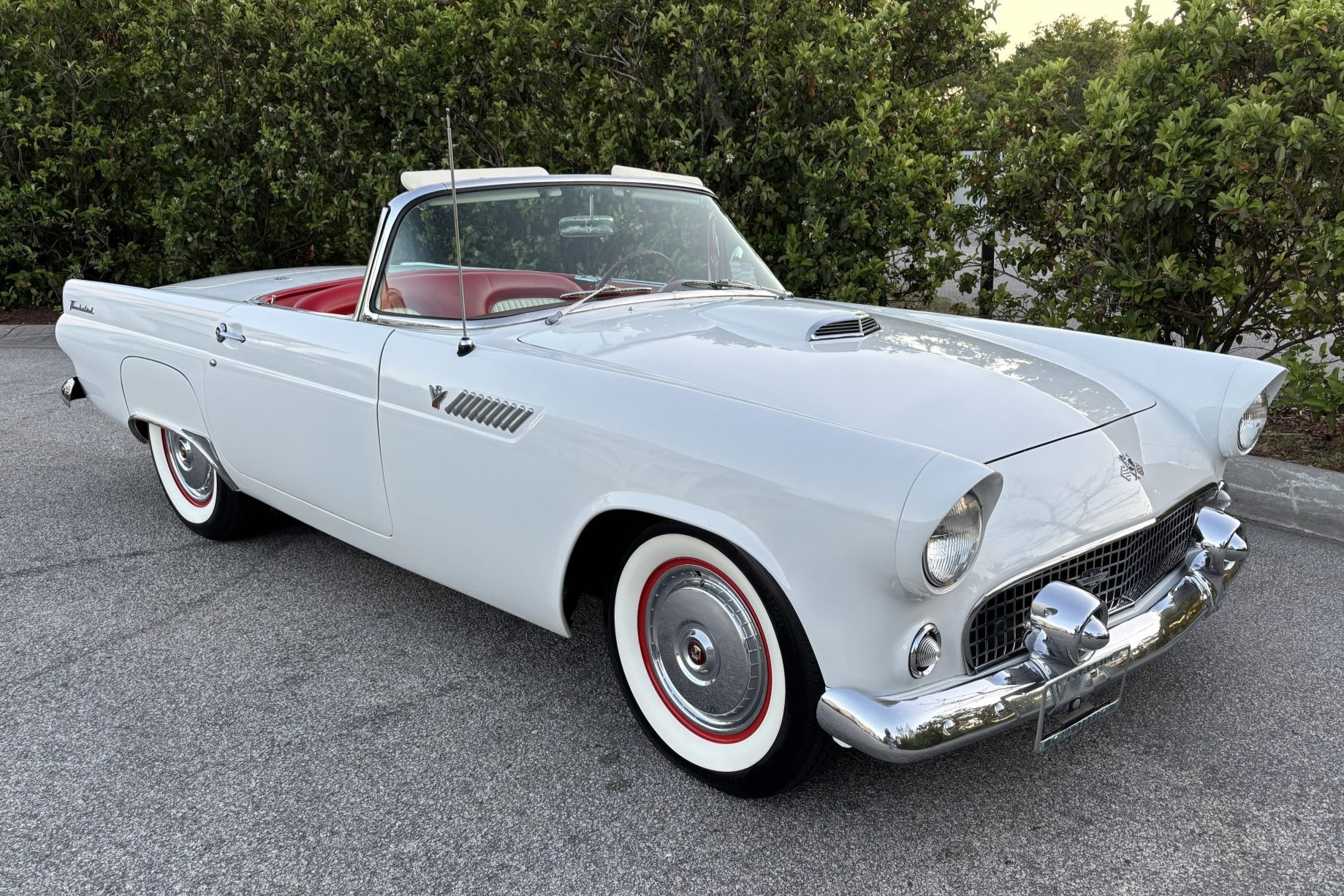 This 1955 Ford Thunderbird was first delivered in Thunderbird Blue with a Turquoise and White interior and 292ci V8 paired with a three-speed Fordomatic automatic transmission. In 1998 it underwent a color change and now sports white paintwork, a color-coordi…