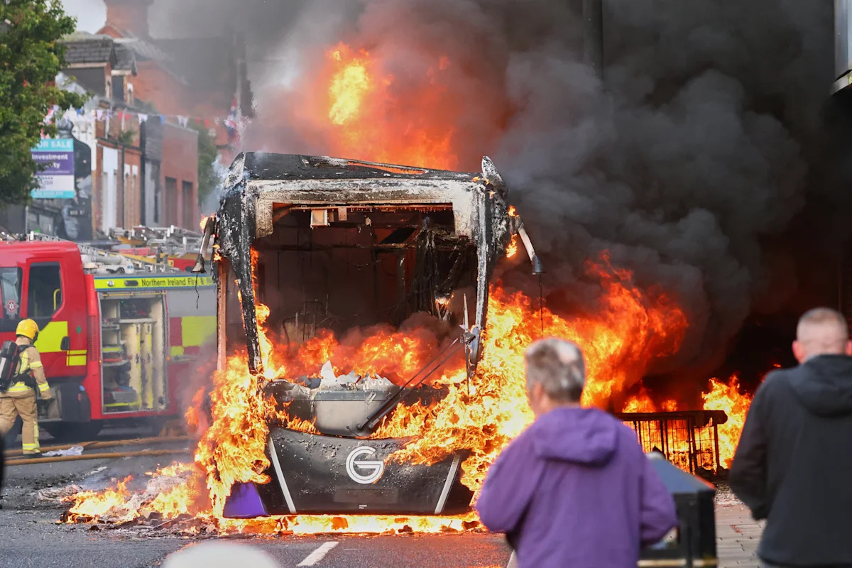 U.K. leaders called for calm Tuesday after the arrest of a Sudanese man accused of trying to kill a man in a vicious stabbing on a Belfast street sparked fie...